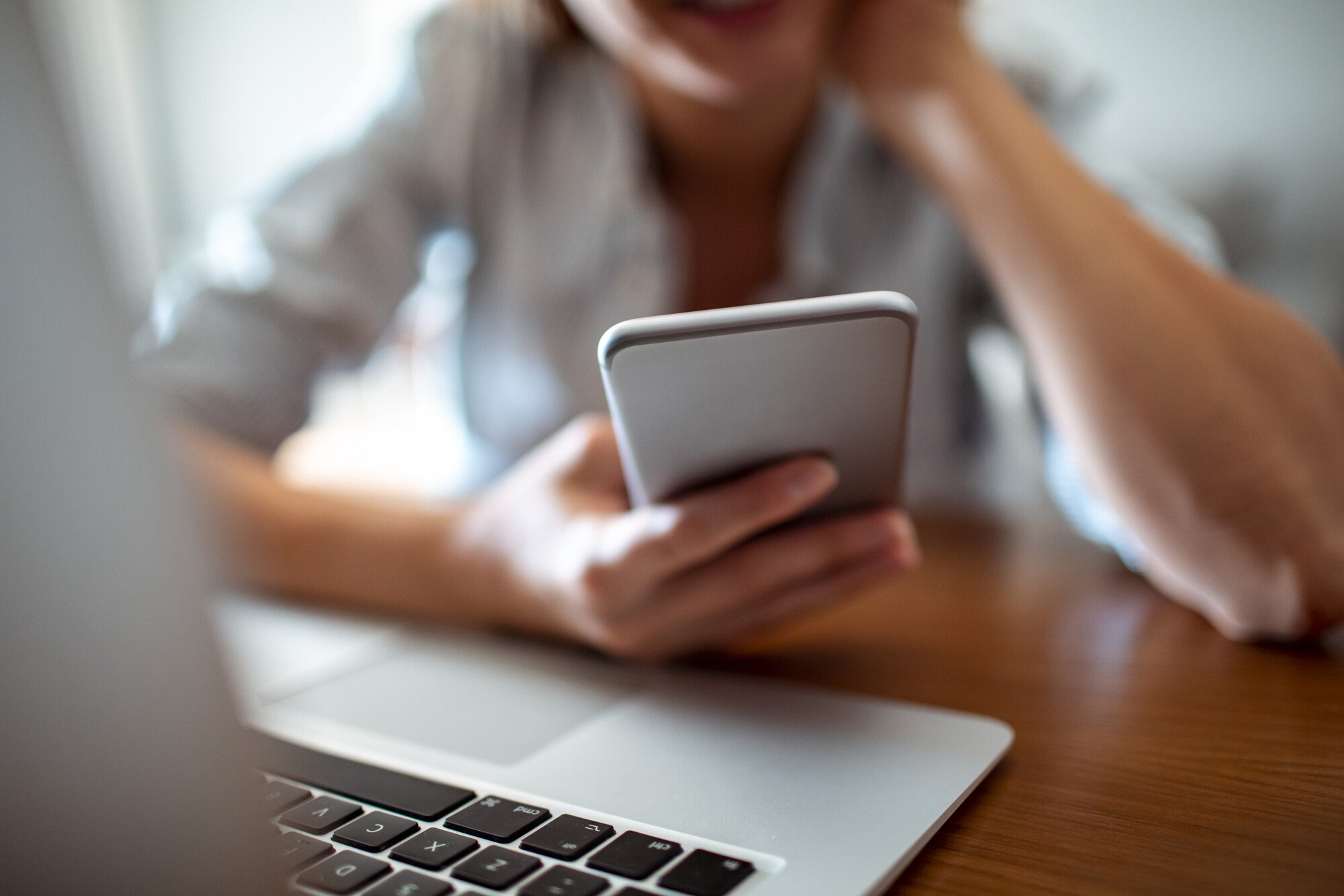 A woman learning how text message fundraising works on her phone.