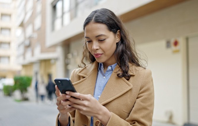 A woman looks at her incoming text-to-give messages.