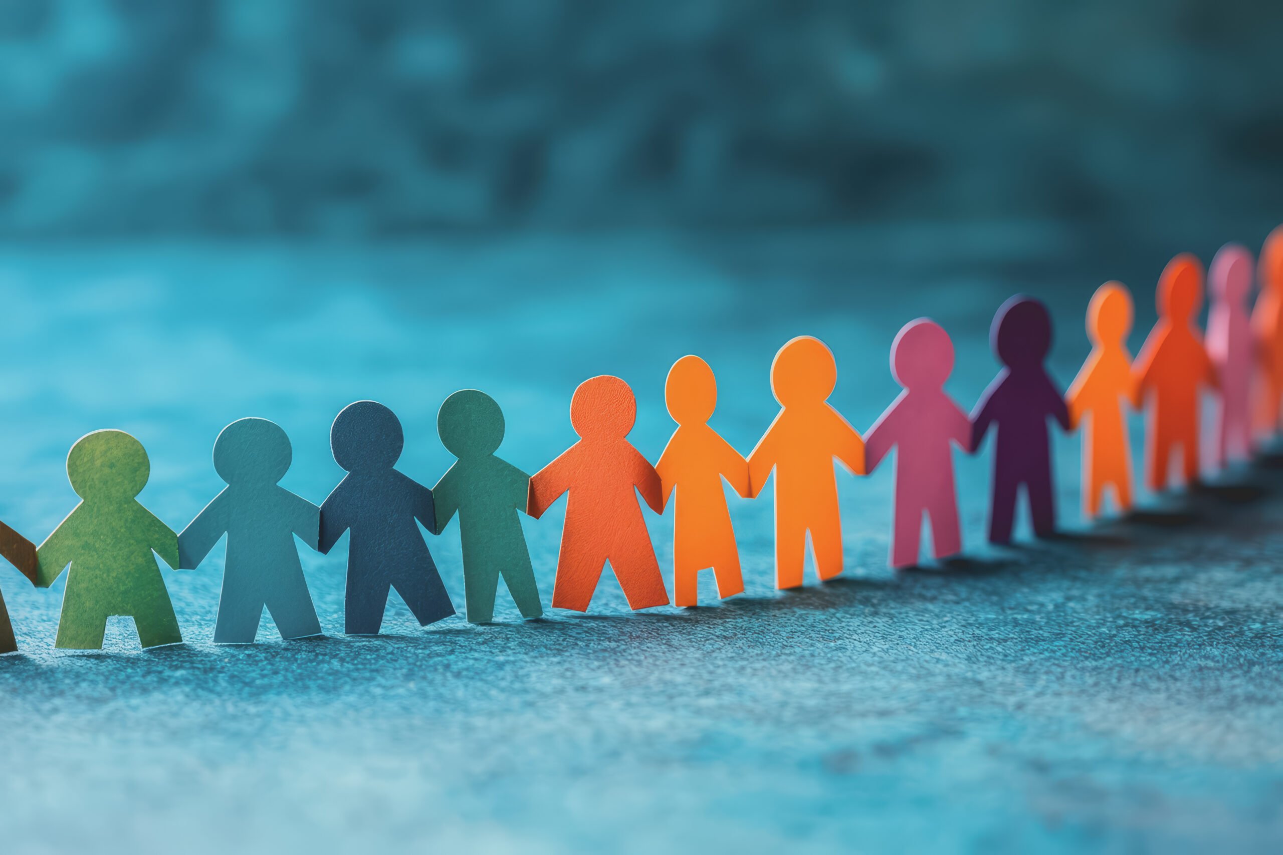 Group of people holding hands helping each other to connect their relationship on a blue background.