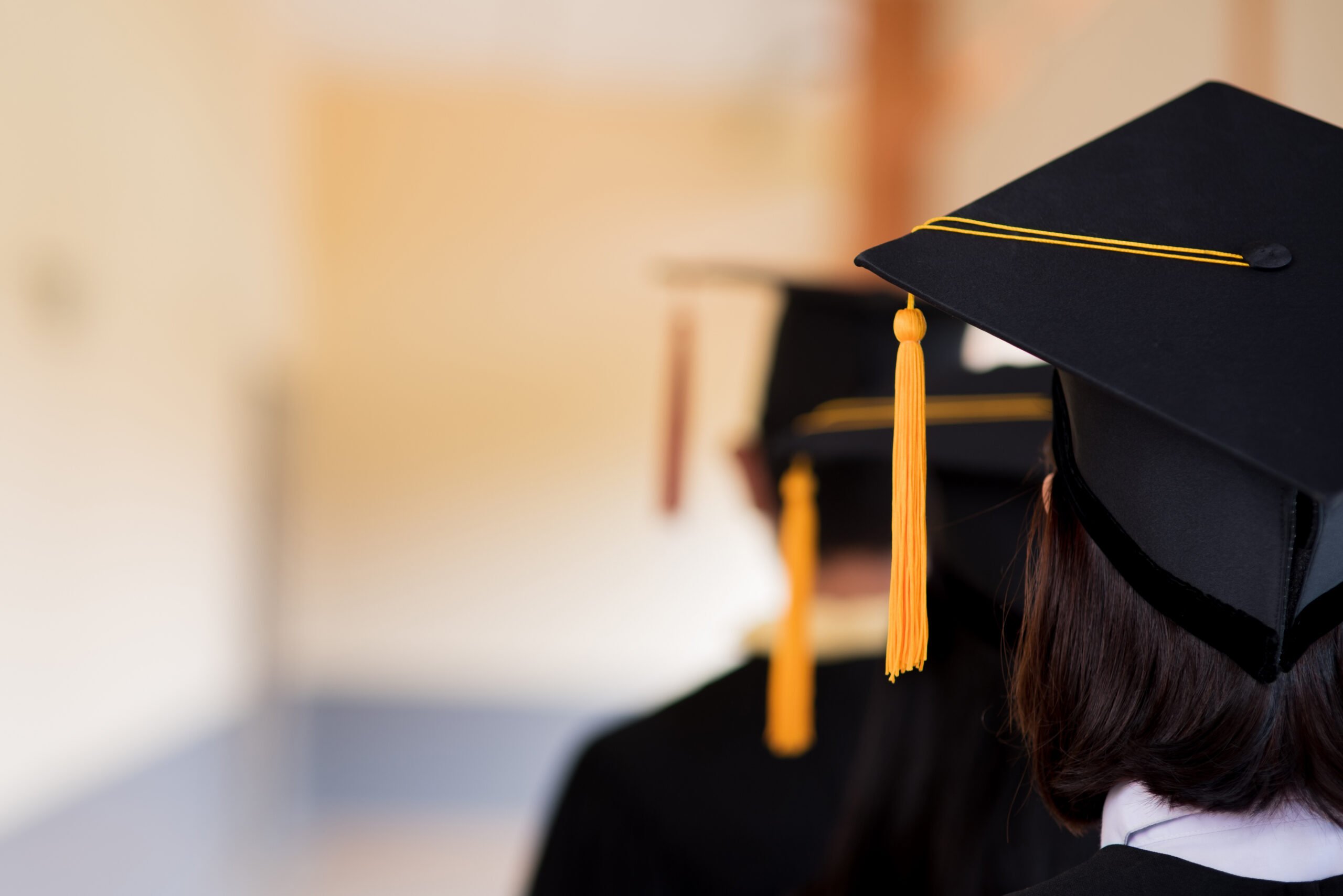 Black graduates wear black suits on graduation day at university.